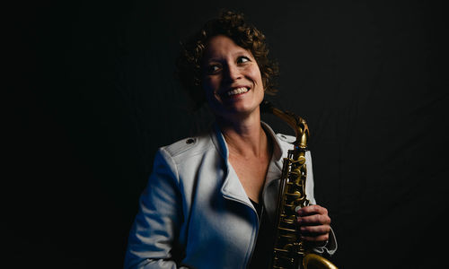 Kasey Knudsen holding a saxophone