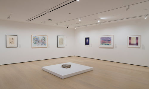 Gallery with works on paper installed on the wall and on a plinth