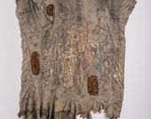 Large brown material in abstract shape similar to a sqaure. The texture mimics bark. 