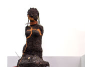 Sculpture of a body made with dirt. 