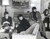 The beatles sit around the studio, shot in black and white