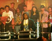 Person DJs for an audience in a warmly lit venue