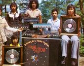 Archival photo of six men,  two holding framed records