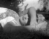 Artist Frida Kahlo laying in the grass