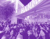 A crowded museum courtyard full of smiling, dancing visitors