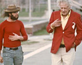 still of two men walking and talking
