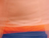 Blurred image of a torso wearing blue shorts with orange boxers peaking above the waistband, the white band of the underwear reading "TOMMY HILFIGER" in black letters