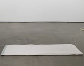 A gray electric blanket on an otherwise empty gallery floor