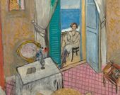 A seated woman seen through an open door, with the ocean visible beyond