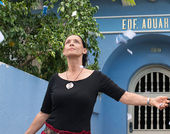 A woman stands in front of a building marked EDF AQUARIUS