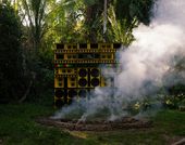 A wall of yellow speakers, surrounded by smoke