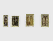 Four pairs of shoes mounted to a wall