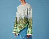 A woman wearing a graphic sweater